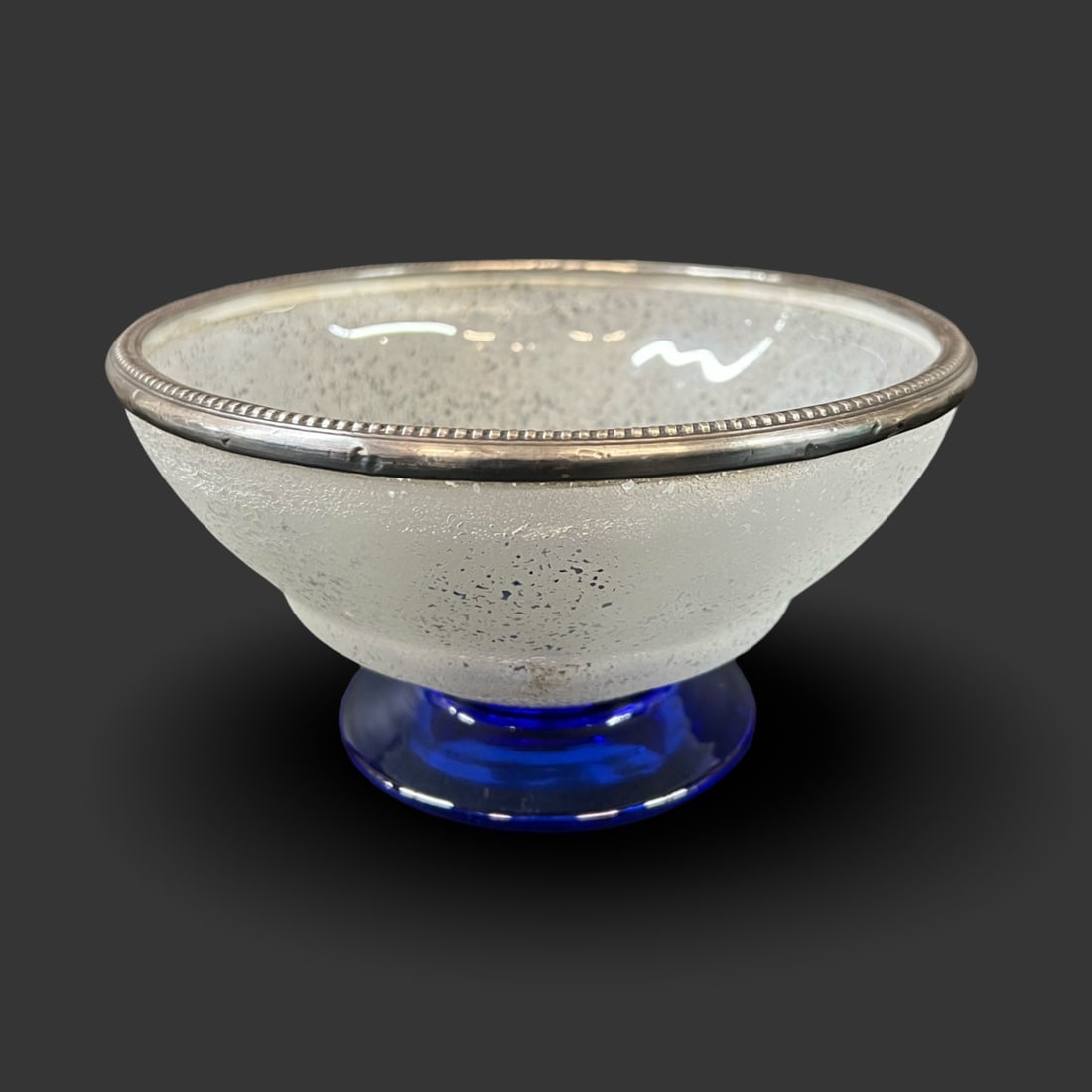 Daum Nancy France Frosted Glass Footed bowl mounted in sterling silver c1920: Daum Nancy France Frosted Glass Footed coupe bowl, rim mounted in sterling silver. Granular texture, cobalt blue foot. Makers mark on underside, silver hallmark on rim. 2.7lbs Measurements: Approx. 8.
