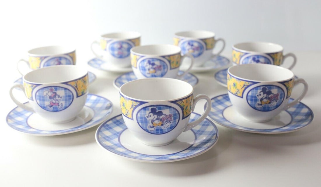Discontinued 8pc Euro Disney Disneyland Paris Coffee Cup / Teacup and Saucers: A Discontinued 8pc Euro Disney Disneyland Paris Coffee Cup / Teacup and Saucers, featuring Mickey and Minnie Mouse, cups feature oval cartouches on two sides, one with Minnie, one with Mickey Mouse, w