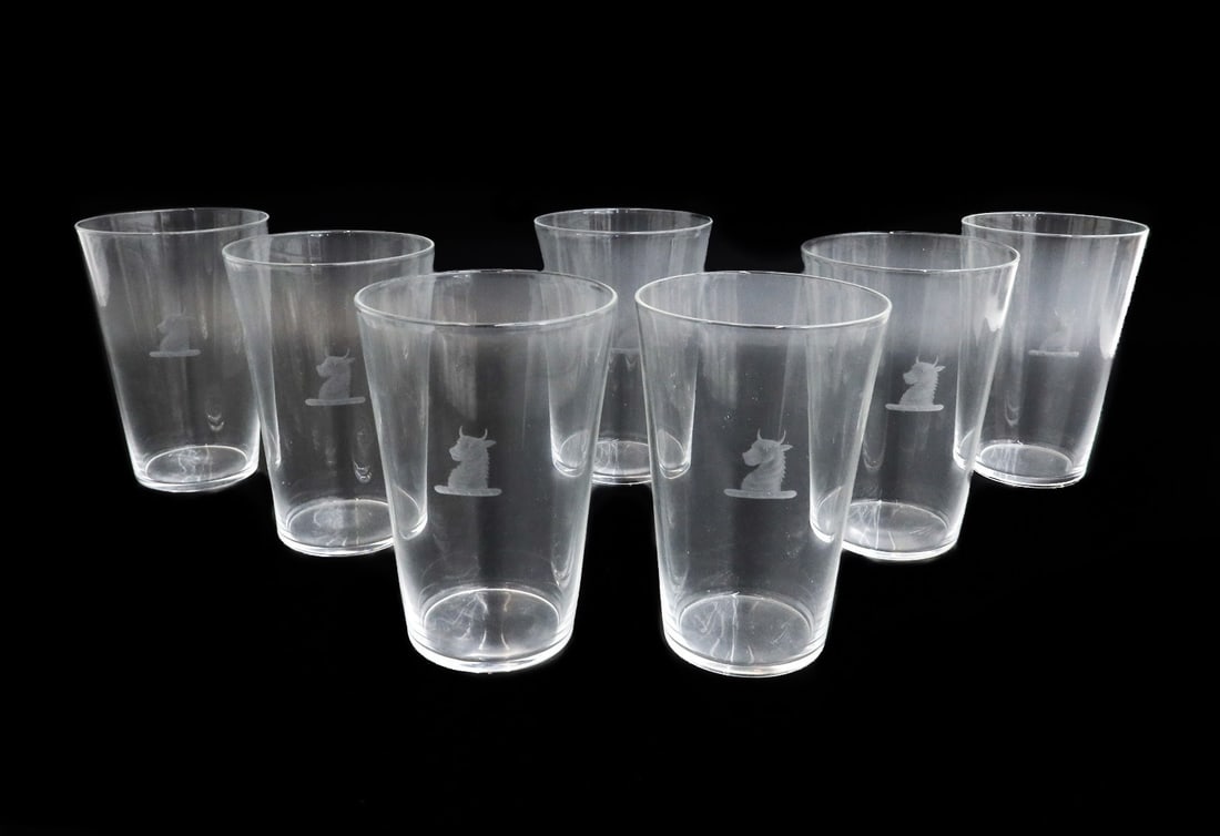 7 Steuben Art Glass Water Tumblers in #7711 Heraldic Emblem Signed: 7 Steuben art glass water tumblers in #7711. Engraved Heraldic emblem of a bull's head representing the Whitney family. Steuben mark "S" to underside. Weight: Approx. 6 lbs Measurements: Approx. 3.625