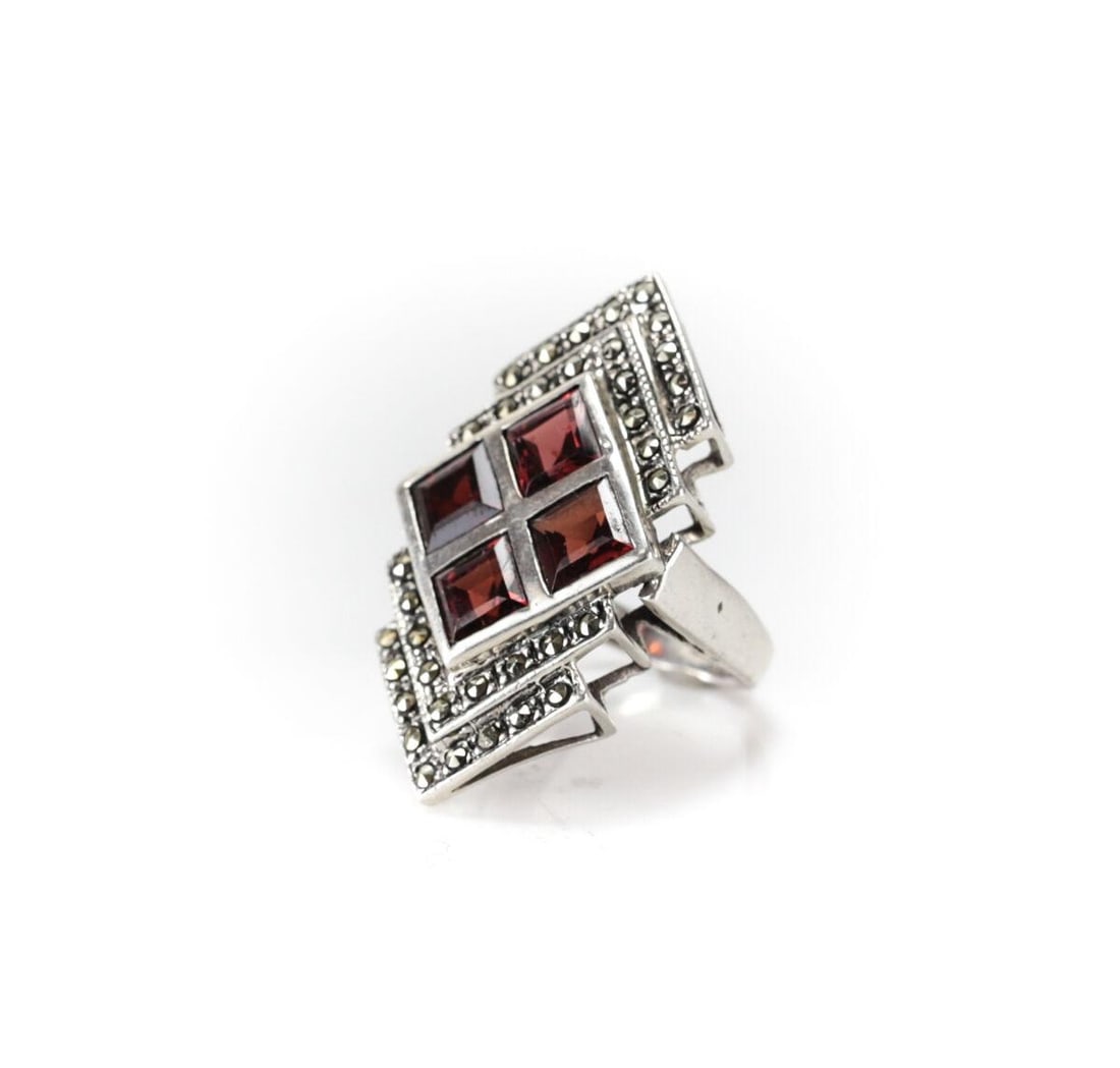 Large Vintage Sterling Silver Garnet and Marcasite Ring Size 6.75 Chevron design: Vintage Sterling Silver Garnet and Marcasite Ring, Size 6.75. Chevron design, square cut deep red stones. Marked 925. 9.4grams Measurements: Approx. ring face 36mm x 20mm; stone 6mm square Condition:
