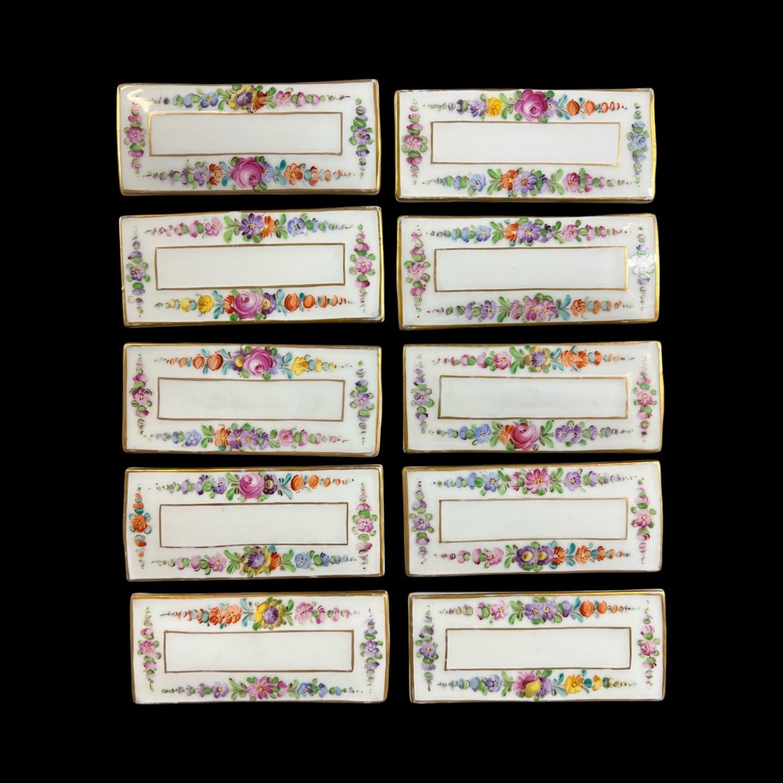 10pc Wehsener Dresden Porcelain Place Holder plaques: Wehsener Dresden Porcelain Place Card Holders, set of 10. First half 20th Century. Hand painted floral designs, makers mark on underside. Glossy rim, matte in the central rectangle. Measurements: Appr