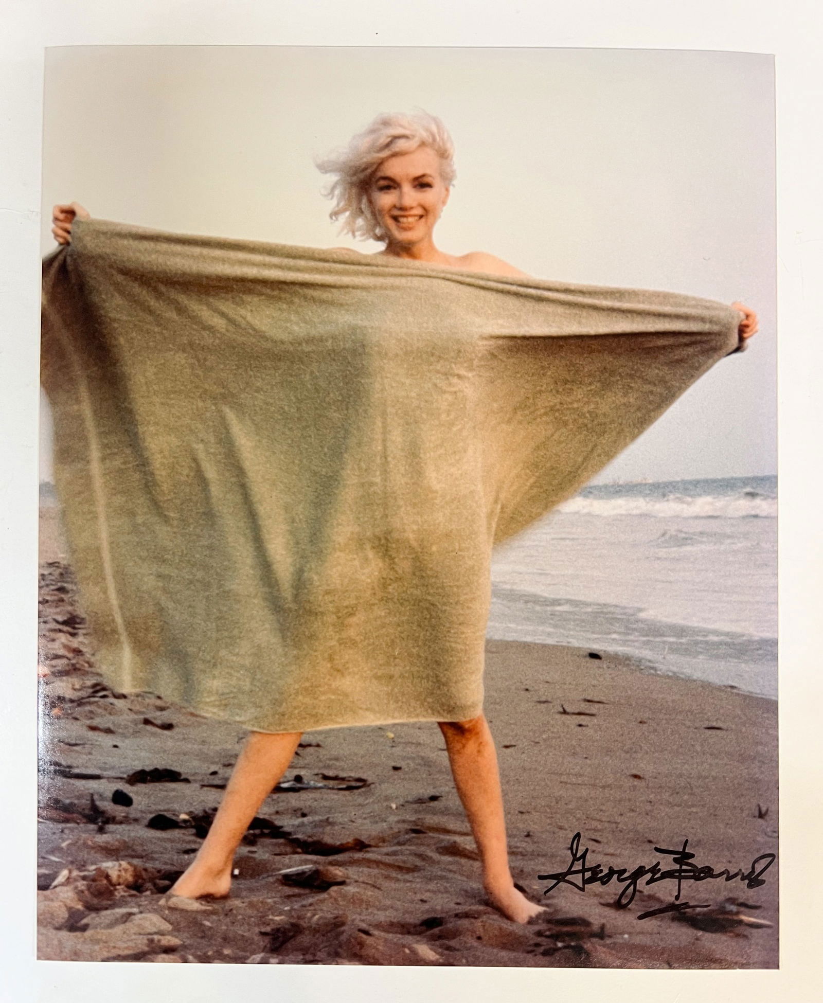Color Photograph Marilyn Monroe by George Barris: A limited edition George Barris color photograph of Marilyn Monroe. Signed by George Barris in marker (lower right). Stamped and numbered on reverse. Marilyn Monroe at Santa Monica Beach in 1962, hold