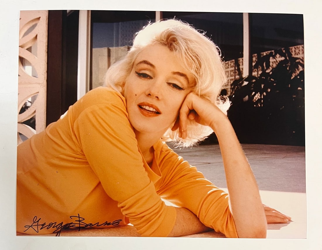 Color Photograph Marilyn Monroe by George Barris: A limited edition George Barris color photograph of Marilyn Monroe. Signed by George Barris in marker (lower left). Stamped and numbered on reverse. Marilyn Monroe at her home in 1962, her head restin