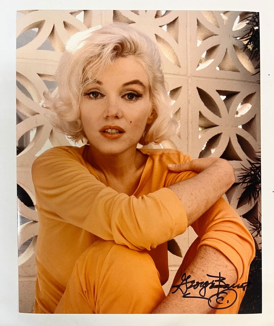 Color Photograph Marilyn Monroe by George Barris: A limited edition George Barris color photograph of Marilyn Monroe. Signed by George Barris in marker (lower right). Stamped and numbered on reverse. Marilyn Monroe at her home in 1962, seated in fron