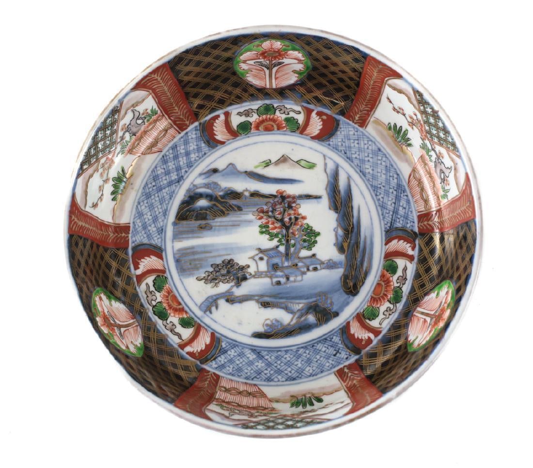 Japanese Imari porcelain rice serving bowl Hand painted: Japanese Imari porcelain rice serving bowl. Hand painted rusts, greens on blue and white. Landscape scene. Raised enamel details on trees. Unknown mark to the underside. 2.75lbs Part of a large collec