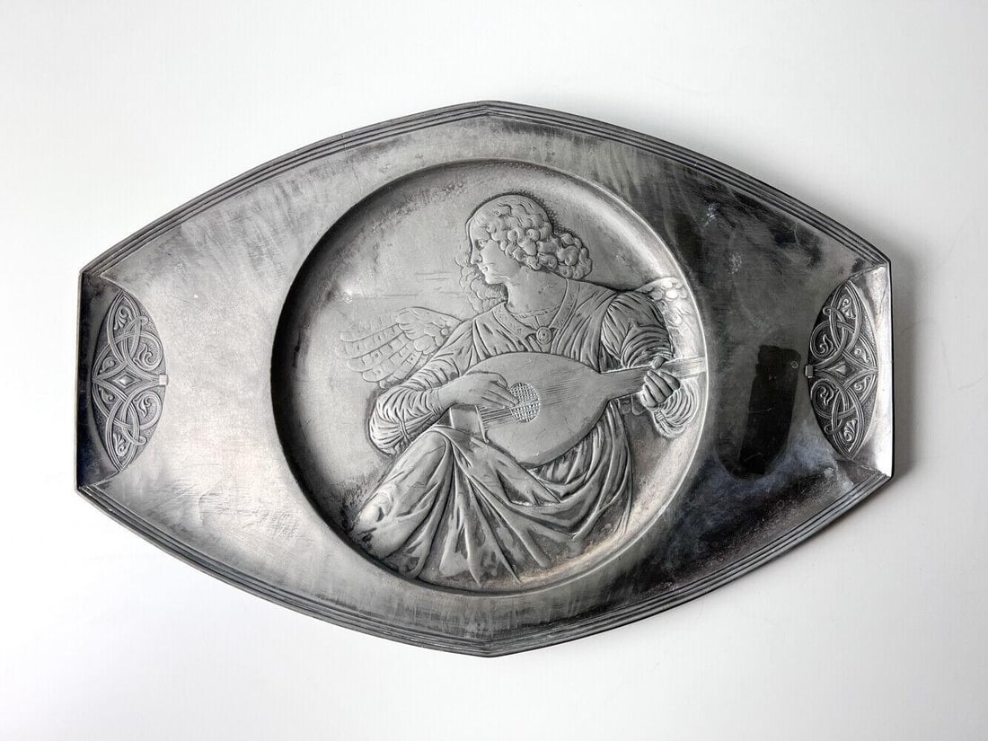 early 20th century Art Nouveau Pewter Wall Plaque Angel playing mandolin: early 20th century Art Nouveau Pewter Relief Wall Plaque, Angel playing mandolin, marked on reverse 305A. Hanger mounted to reverse. Last photo of old print of plaque. 2.7lbs Measurements: Approx. 16.