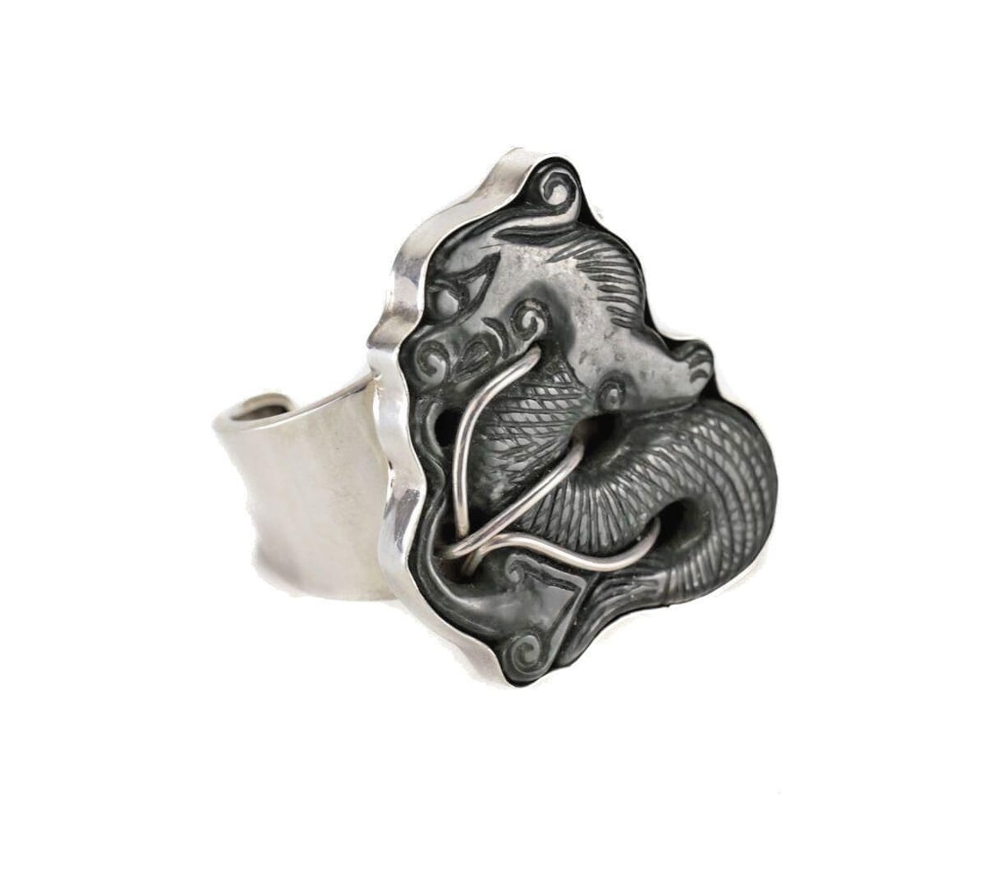 Vintage Sterling Silver and Nephrite Jade Dragon Cuff Bracelet: Vintage Sterling Silver and Nephrite Jade Dragon Cuff Bracelet. Large dark green hand carved dragon in a simple silver setting, on reverse signed by artist (difficult to discern) USA. 75.5grams Measur