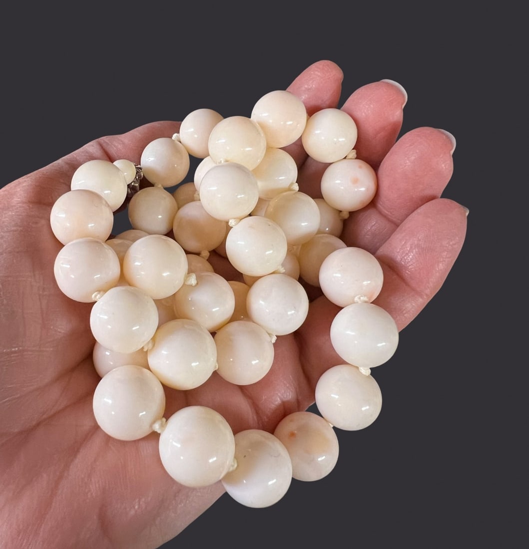 9k white gold Beaded Angel Skin Coral Necklace 26" 13mm: Beaded Angel Skin Coral Necklace with 9k white gold closure with pearl; large 13mm beads, creamy white and pink. Knotted between beads. Measurements: Approx. 4.896ozt; 13mm beads, 26 inches length Con