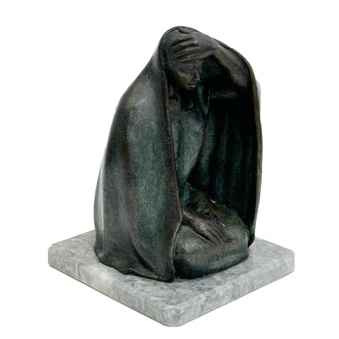 Salvador Jaramillo Mujer con Manto Woman with Cloak Bronze Sculpture Signed: Salvador Jaramillo (Mexico b. 1964) Mujer con Manto Bronze Sculpture on marble Base. Depicts a woman with a cloak over her head, her arm raised. Back edge of bronze signed S Jaramillo dated 87. Mounte