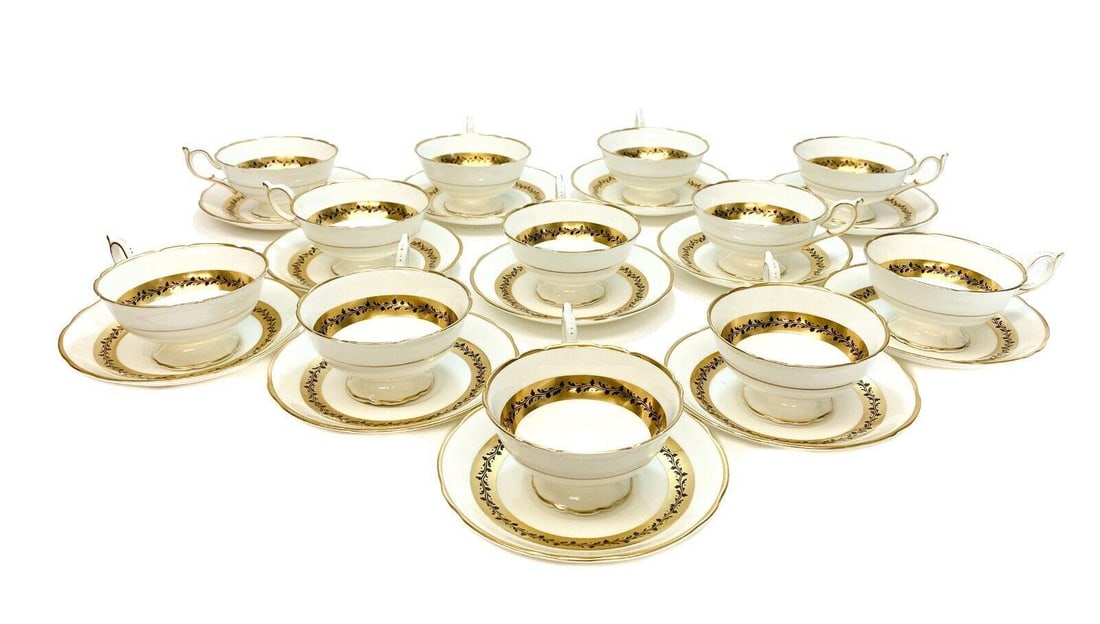 12 Coalport England Cup & Saucers in Citation, circa 1950. Gold Trim: 12 Coalport England cup & saucers in Citation, circa 1950. Gold band trim with black vines. Coalport England mark to the underside. Weight: Approx. 8 lbs Measurements: Approx. Cup: 5 inches x 4 inches