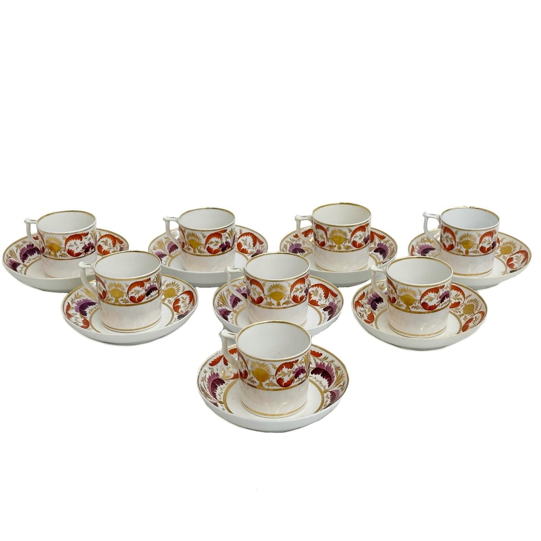 8 Royal Crown Derby Hand Painted Porcelain Cup and Saucers circa 1810: 8 Royal Crown Derby Hand Painted Porcelain cup and saucers, circa 1810. A white ground, decorated to the edge with red green and gilt foliate designs. Gilt decoration to the center. Underside with red