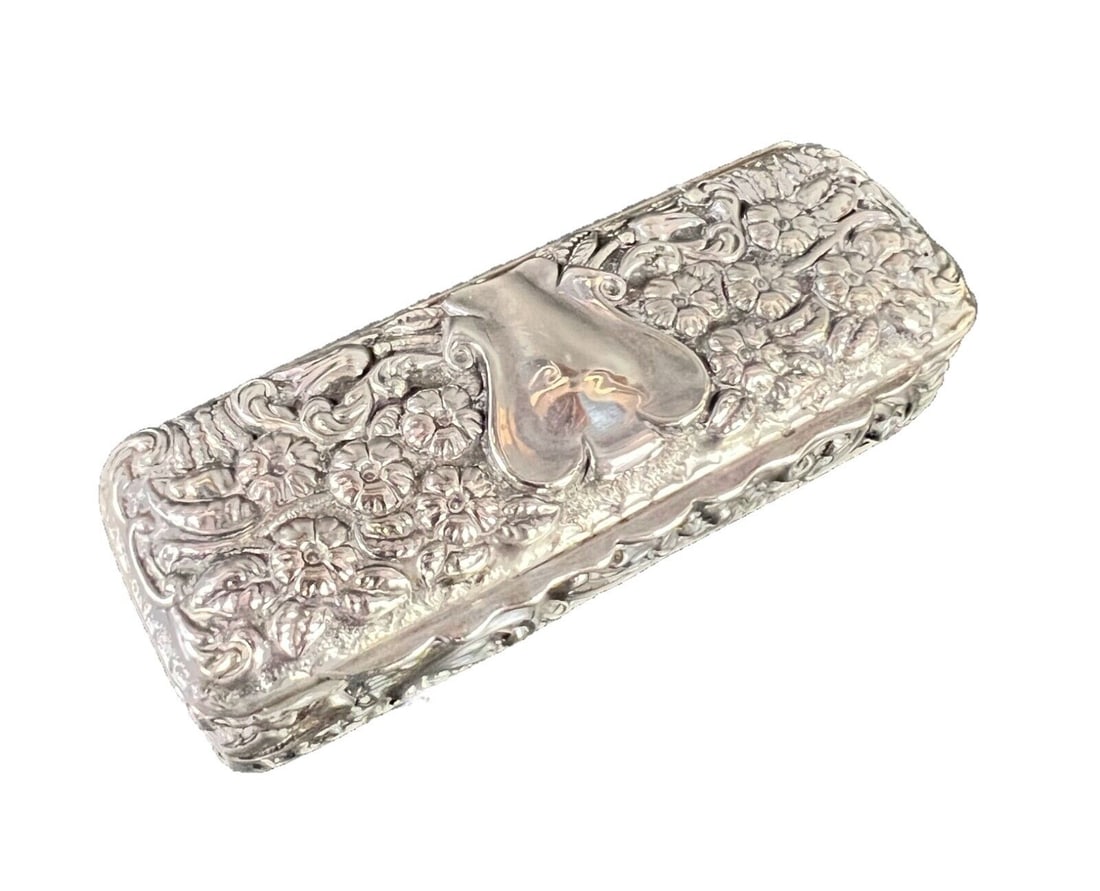 English Sterling Silver Snuff Box George Nathan & Ridley Hayes 1904: English Sterling Silver Snuff Box, repousse floral and foliate designs, vacant cartouch on the lid. George Nathan & Ridley Hayes Chester 1904. Measurements: Approx. 53grams. 3.5 x 1.375 x 1 inches Con