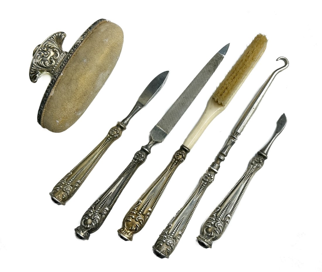 Foster and Bailey Gilt Wash Sterling Silver Manicure Vanity Set circa 1900: Foster and Bailey gilt wash sterling silver manicure vanity set, circa 1900. Beaded foliate scrolls to handle and a purple glass jewel to finial. Each marked with Foster and Bailey sterling silver hal