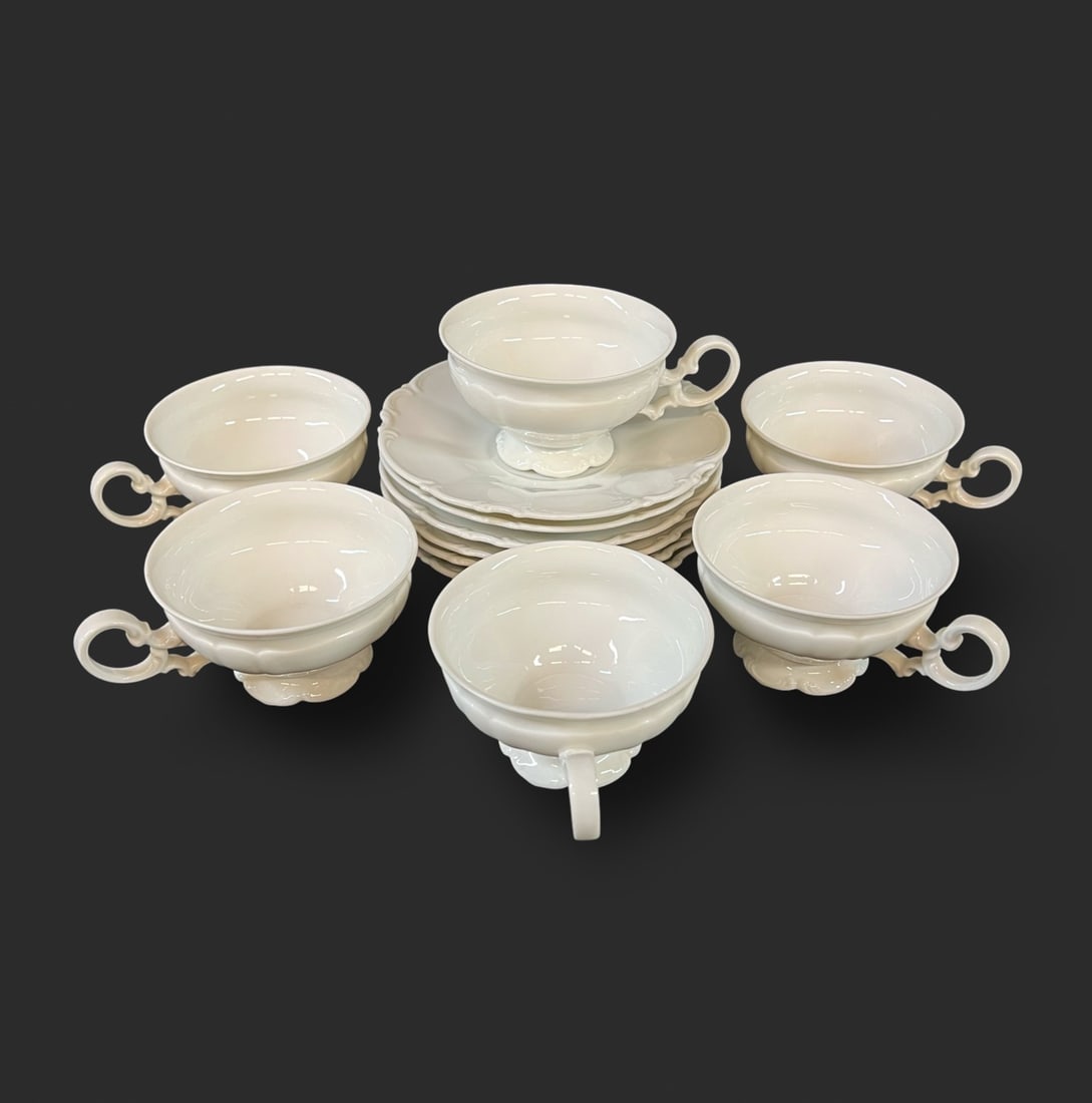 Hutschenreuther SILVIA Footed Cup and Saucers 6pc set: Hutschenreuther SILVIA Footed Cup and Saucers. A 6 piece set of all white saucers and footed cups with scroll and scalloped rims. Makers marks on the underside. c1962-87. 3.5lbs Measurements: Approx.