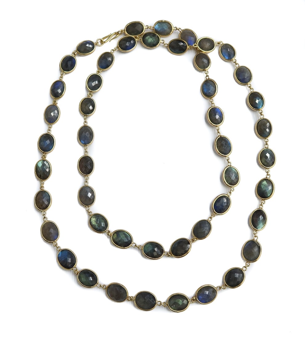 18k Yellow Gold and Bezel Oval Faceted Cut Labradorite Necklace: 18k Yellow Gold and Bezel Oval Faceted Cut Labradorite Necklace. 47 oval faceted labradorites measuring approximately 11.7mm x 9mm x 6mm. Marked 18k to clasp. Weight: Approx. 63.48 grams Measurements: