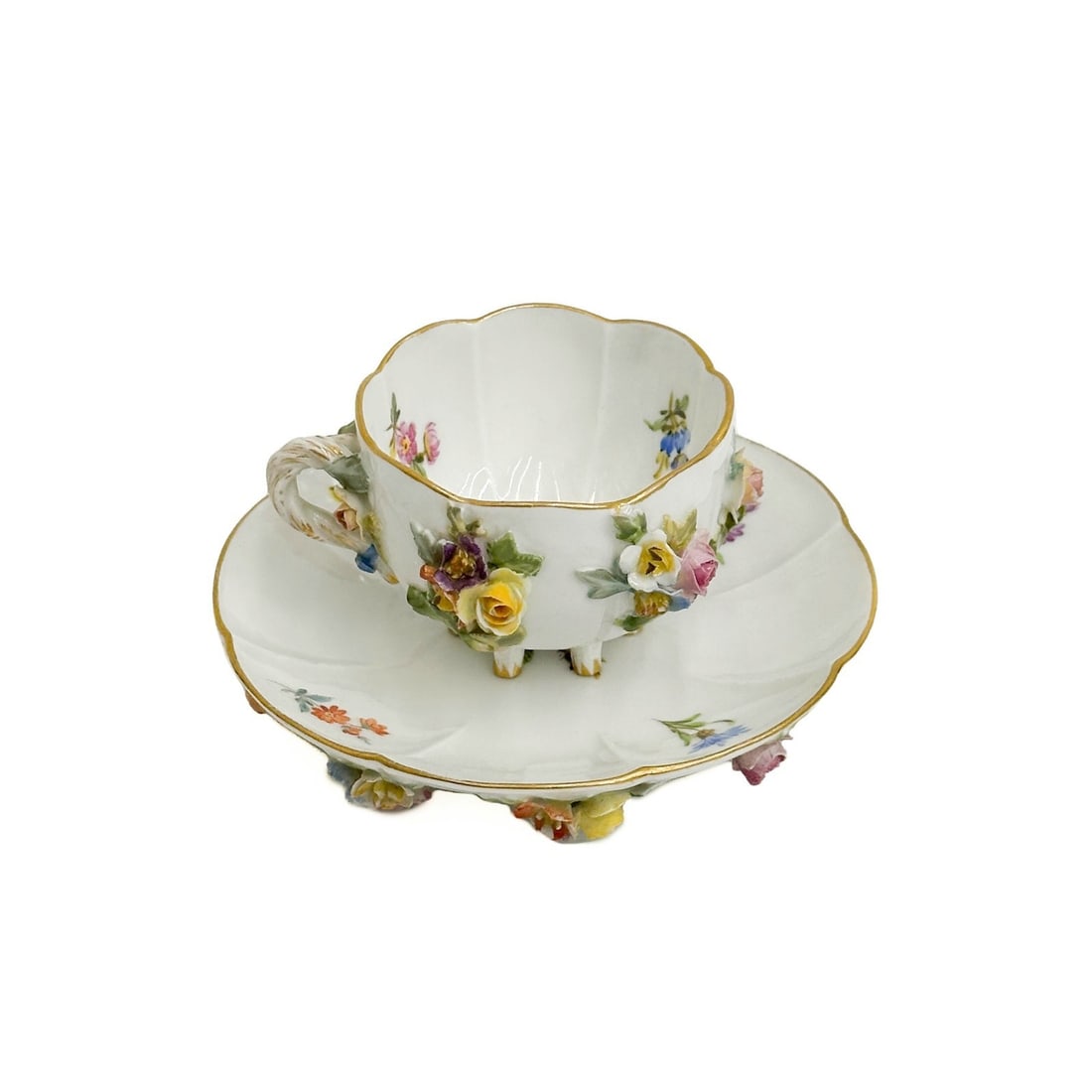 Meissen Germany Porcelain Footed Cup & Saucer Raised Florals c1900: Meissen Germany Porcelain Footed Cup and Saucer, circa 1900. A white ground decorated with colorful raised florals. Underside with Meissen crossed swords marks. Weight: Approx. .5 lb Measurements: App