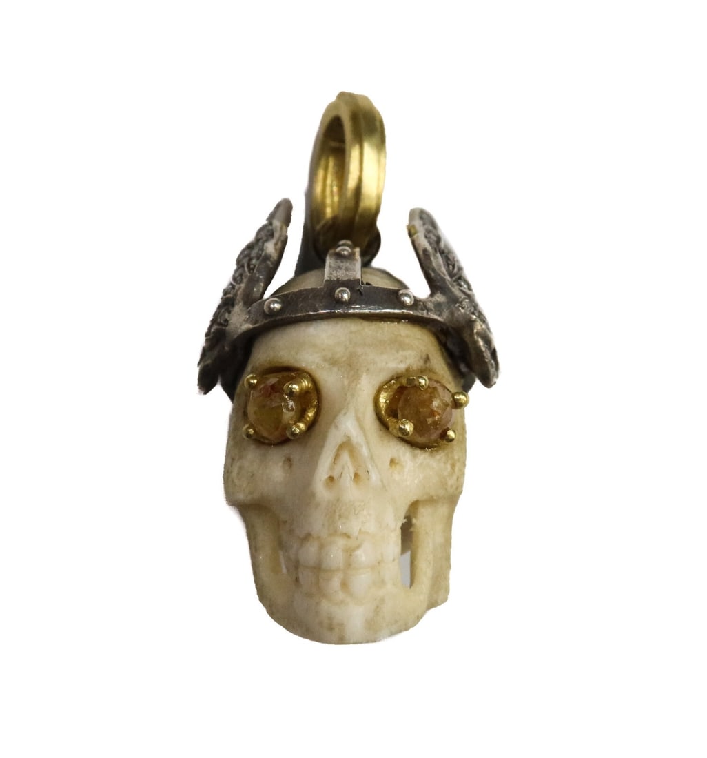 Sylva and Cie 18k Gold Sterling Silver Diamond Elk Bone Skull Pendant: Sylva and Cie 18k gold sterling silver and diamond elk bone skull pendant. Carved elk bone skull with a sterling silver winged crown embedded with round cut diamonds. Yellow diamonds to eyes. The diam