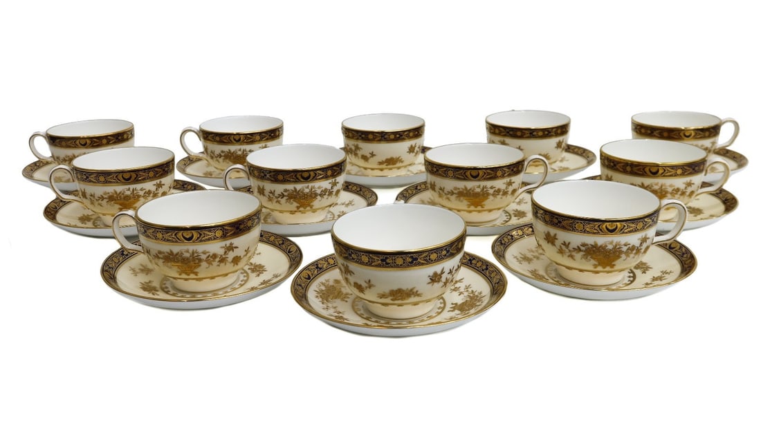 12 Minton England Porcelain Gold Encrusted Cup and Saucers in Dynasty: 12 Minton England porcelain cup and saucers in Dynasty, Mid Century. Cobalt blue ground to rim with gold encrusted florals. Minton England mark to underside. Weight: Approx. 13 lb Measurements: Approx