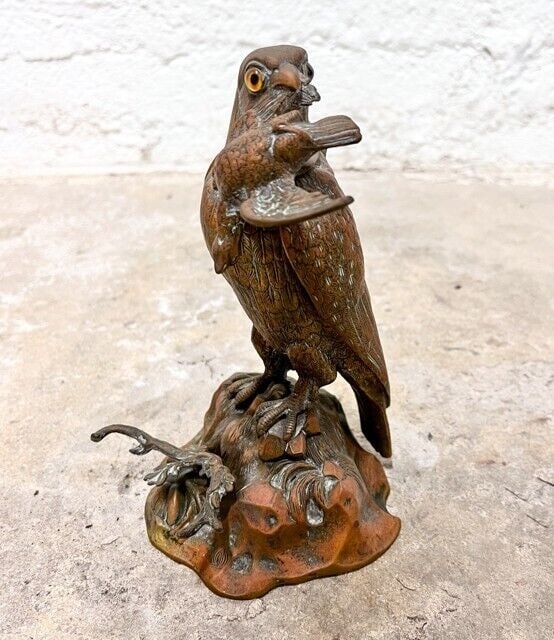 Continental Bronze Falcon with Prey branch form pen rest: Bronze Falcon with Prey, branch form pen rest. Glass eyes. The raptor is perched on a crag. Head hinges open to reveal porcelain inkwell. Unmarked. Plaster filled for weight. Approx 3.9lbs Measurement