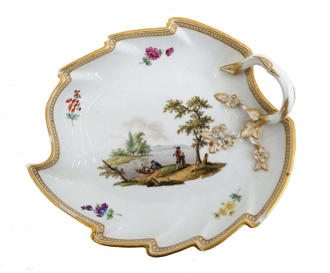 Meissen Marcolini Germany Porcelain Hand Painted Leaf Handled Dish c1880: Meissen Marcolini Germany porcelain hand painted leaf handled dish, circa 1880. Hand painted lake genre scene to center with multi-colored flowers to edge. Gilt accents throughout. Meissen mark to und
