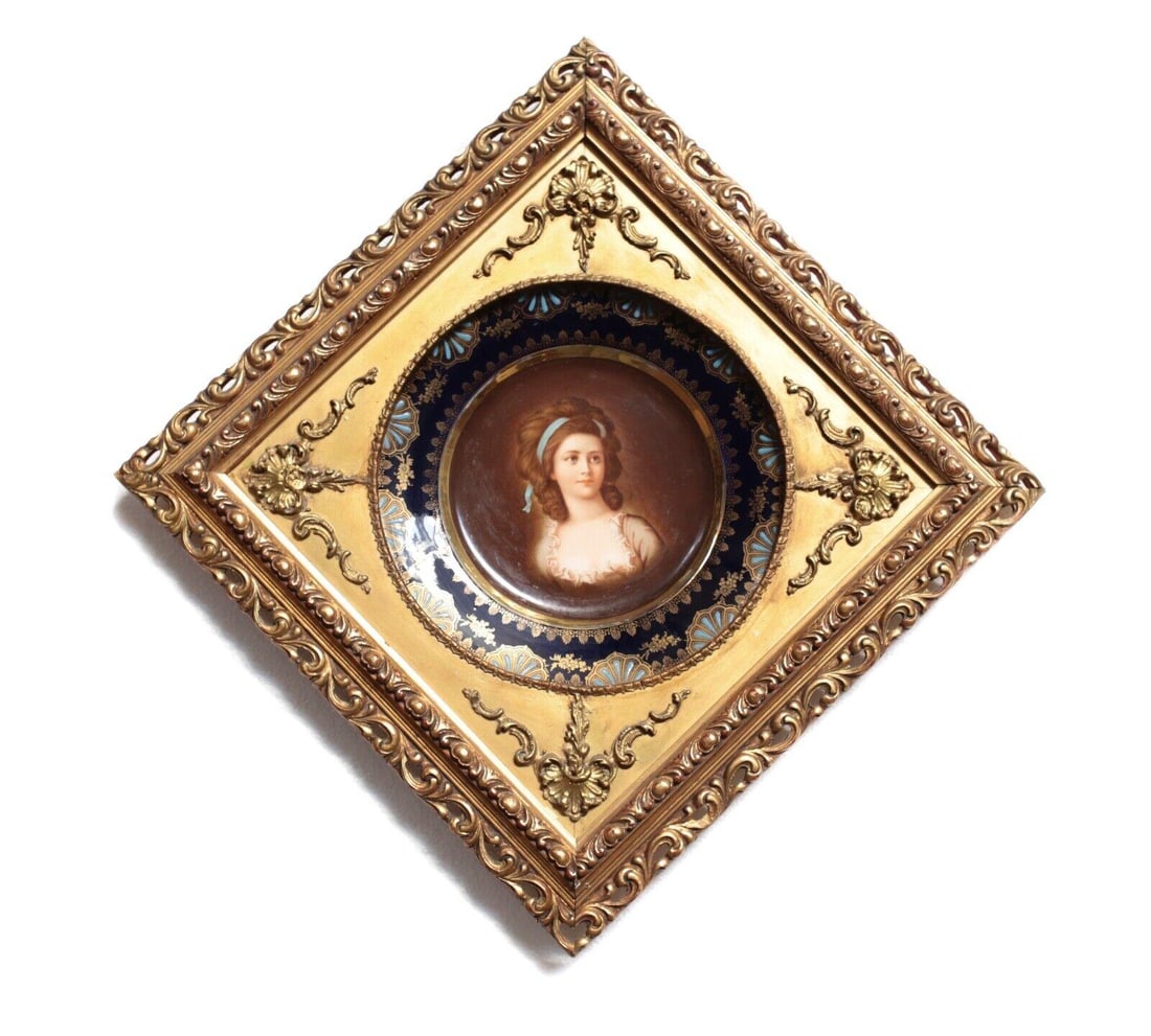 Hand Painted Cabinet Portrait Plate, Young woman, with blue ribbon in her hair: Hand Painted Cabinet Portrait Plate, Young woman, with blue ribbon in her hair. Raised enamel details along the rim, gilt. Underglaze beehive mark on reverse. 3lbs Measurements: Approx. plate 9.5" dia