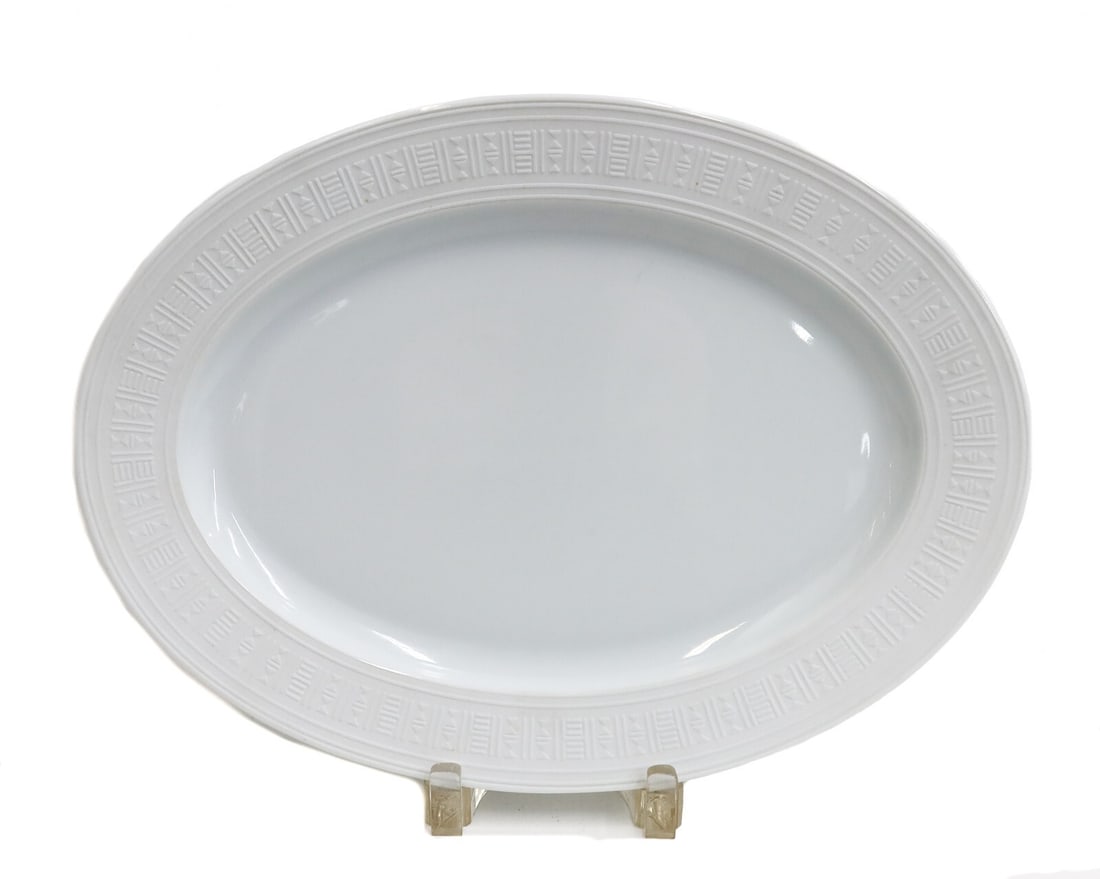Hermes France Porcelain 14 inch Oval Serving Tray in Egee: Hermes France Porcelain 14 inch Oval Serving Tray in Egee. Embossed triangles and lines to rim. Hermes Egee mark to underside. Weight: Approx. 1 lb Measurements: Approx. 14.5 inches x 10.5 inches Cond
