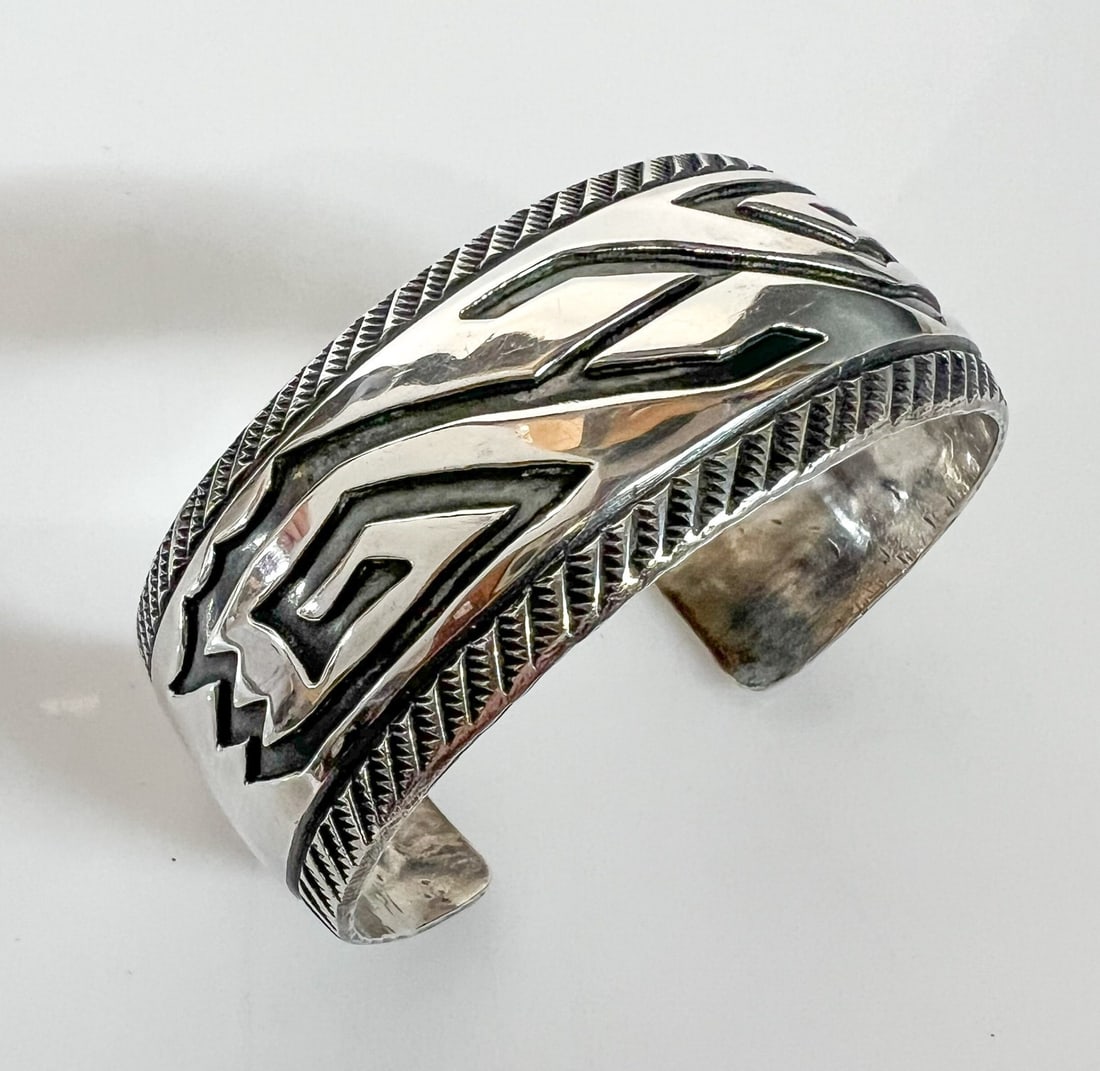 Vintage Navajo Cuff Bracelet: Vintage Navajo Cuff Bracelet, deeply engraved and stamped designs. Unmarked, tested silver Measurements: Approx. 43.88grams (1.4107ozt); 5.75 inches circumference end to end with 1.125 in gap x 1 inch