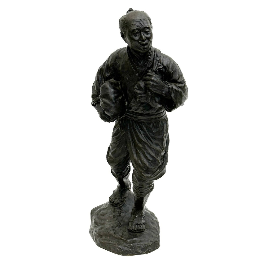 Japanese Bronze Okimono Sculpture of a Man Meiji Period: Japanese Bronze Okimono Sculpture of a Man, Meiji period. Depicts a man holding a package, apparently without maker's mark Weight: Approx. 11 lbs Measurements: Approx. 7 inches x 4.75 inches x 15.5 in
