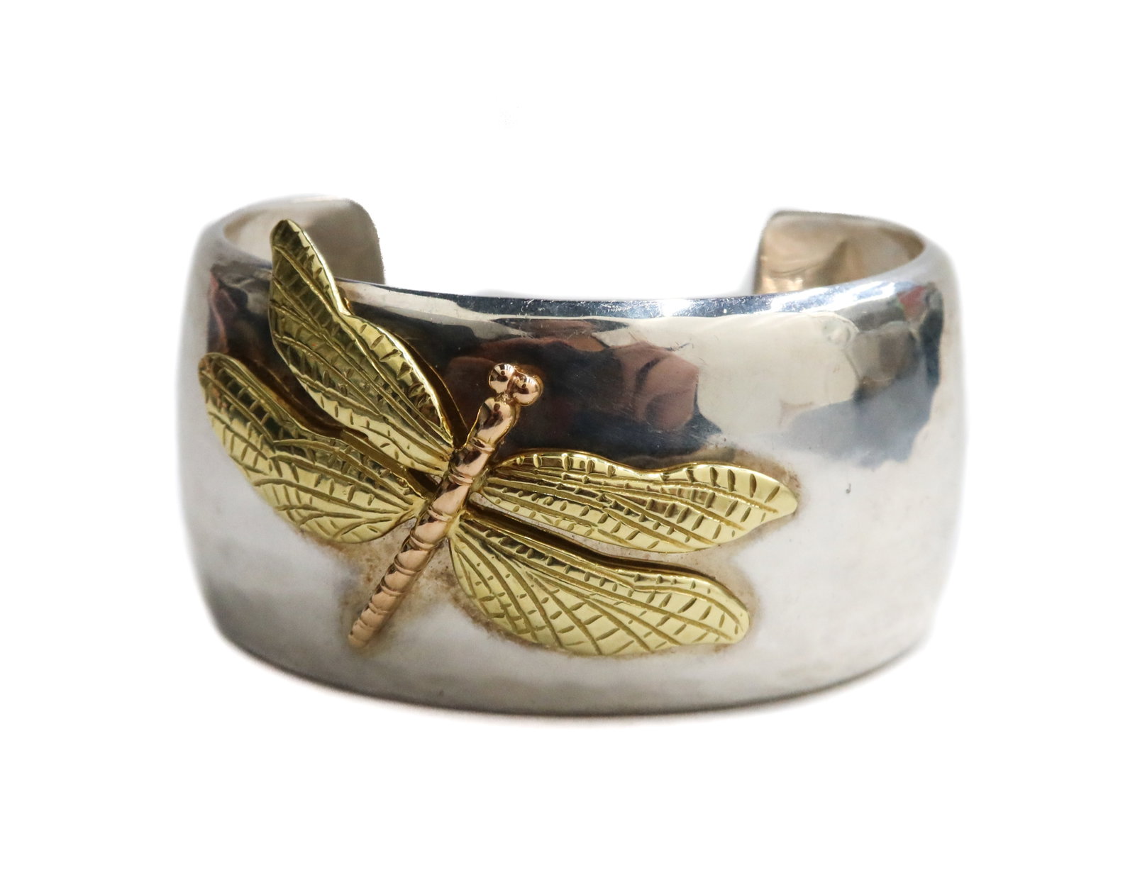 Tiffany & Co. Hand Hammered 2 Tone 18k Yellow and Rose Gold Dragonfly Cuff Bracelet: Tiffany & Co. hand hammered 2 tone 18k yellow and rose gold dragonfly cuff bracelet. Hand hammered texture to the silver with an applied 18k yellow and rose gold dragonfly to the center. Tiffany & Co.