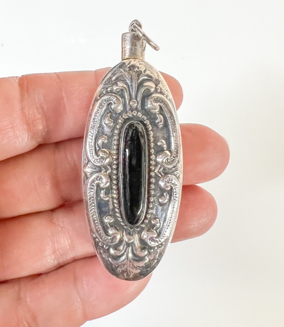 Sterling Silver & Black Onyx Snuff or Perfume Bottle Fob Pendant: Sterling Silver & Black Onyx Snuff or Perfume Bottle Fob Pendant, C-scroll designs. Marked Sterling. Spoon and bottle tested silver Measurements: Approx. 15.19grams; 2.25 x 0.875 x 0.5 inches Conditio