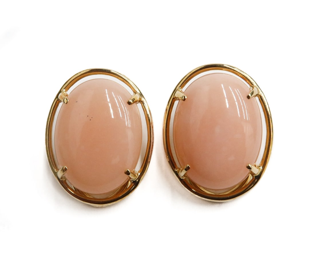 Pair Gump's 14k Yellow Gold Cabochon Coral Clip on Earrings: Pair Gump's 14k Yellow gold cabochon coral clip on earrings. The coral measuring approximately 16mm x 12.1mm x 4.5mm. Marked Gump's 14k. Weight: Approx. 7.53 grams Measurements: Approx. 0.75 inches x 