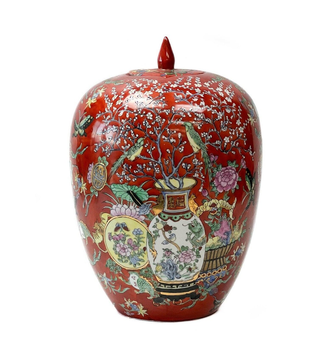 20th century Chinese Hand Painted Porcelain Red Lidded Jar Insects Florals: Chinese hand painted porcelain lidded jar, 20th century. A red ground with colorful images of vases, cherry blossoms, birds, and insects. Gilt accents. Underside with Chinese maker's mark. Weight: App