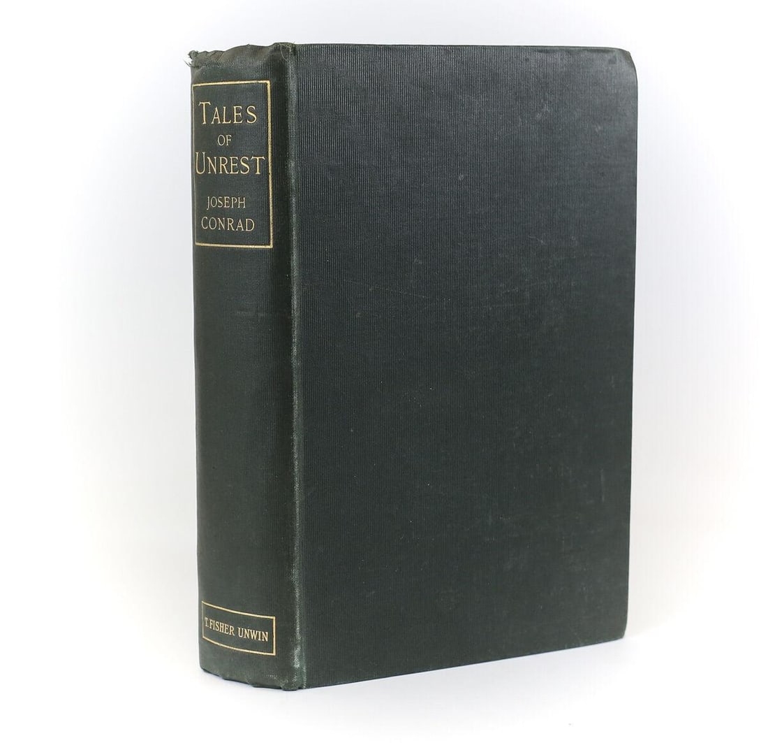 Joseph Conrad 'Tales of Unrest' T. Fisher Unwin, London, 1898. 1st Edition: Conrad, Joseph 'Tales of Unrest' T. Fisher Unwin, London, 1898. 1st Edition hardback book w/ Dark green cloth boards and gold lettering. Deckled Pages, gilt top edge. 297pp. Weight 1.5 pounds. Measure