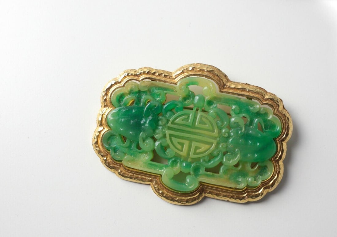 Vintage Vendome Goldtone and Faux Jade Brooch in a Chinese style design: Vintage Vendome Goldtone and Faux Jade Brooch - carved in a Chinese style design. Marked 'Vendome'. Measurements: Approx. 3 inches x 2.25 inches Condition: Very good condition, small chip to edge of j