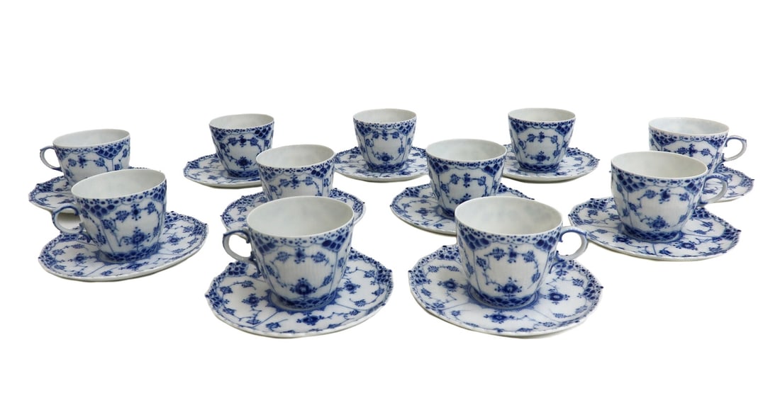 11 Royal Copenhagen Denmark Porcelain Full Lace No Trim Cup and Saucers #1035: 11 Royal Copenhagen Denmark porcelain full lace no trim cup and saucers #1035, Mid Century. Delicate blue floral design with a no trim lace edge. Underside with Royal Copenhagen marks #1035 dating to 
