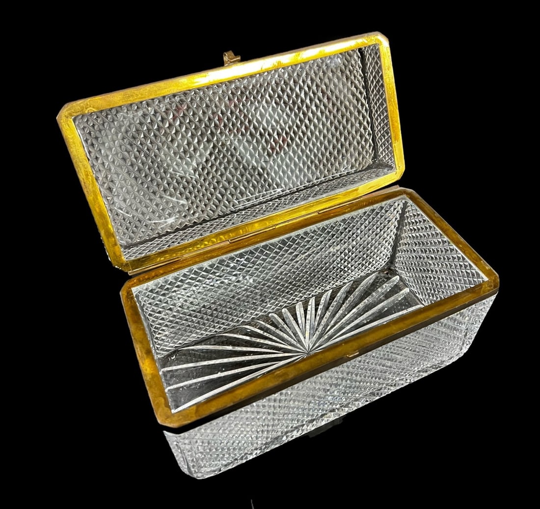 Baccarat Gilt bronze and Cut Crystal Box 19th Century: Gilt bronze and Cut Crystal Box or Casket, hinged lid, criss cross or diamond cuts, canted corners. Likely French, in the style of Baccarat. 5.2lbs Measurements: Approx. 9.75 x 4.5 x 5.5 inches Condit