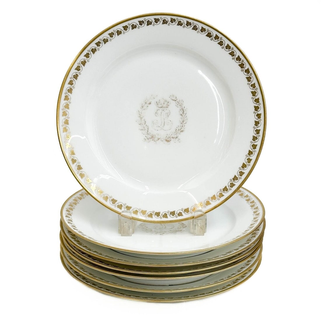 7 Manufacture de Sevres Louis Philippe Gilt Porcelain Plates Chateaux 1838-47: 7 Sevres France Louis Philippe Gilt Porcelain Plates. A white ground decorated with gilt ivy leaves to the edge, stylized monogram to the center beneath a crown, framed by a laurel wreath. Underside w