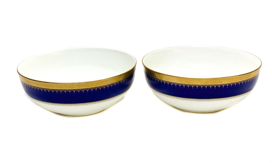 Pair Oscar De La Renta Bone China Round Serving Bowls in Dinner at Eight: Pair Oscar De La Renta bone china round serving bowls in Dinner at Eight. A cobalt blue and white ground with gilt foliate scrolls and beaded designs around the rim. Marked Oscar De La Renta to the un