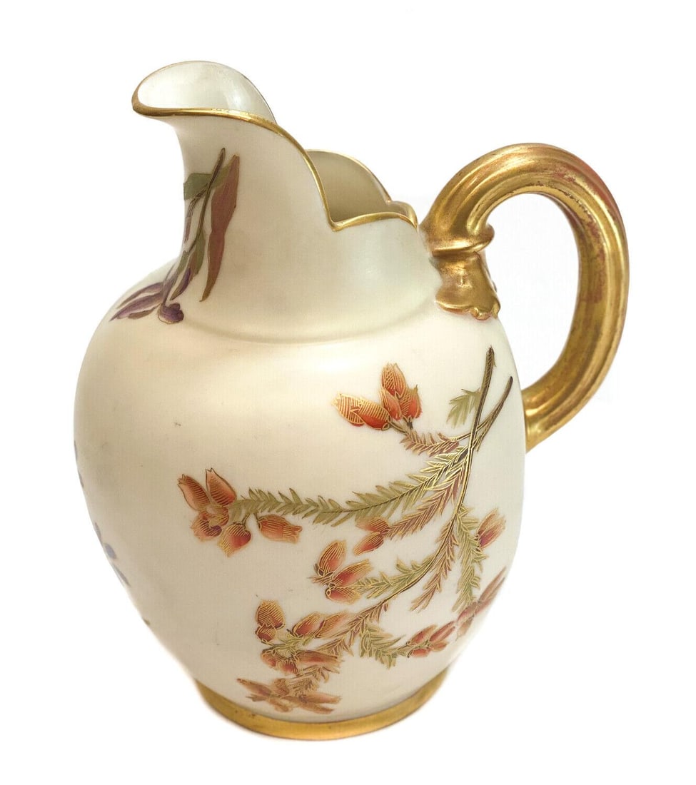 Royal Worcester Hand Painted Porcelain Blush Ivory 6.25 inch Pitcher: Royal Worcester hand painted porcelain blush ivory 6.25 inch pitcher. Hand painted multi-colored flowers throughout. A gilt ribbed handled. Royal Worcester mark to the underside. Weight: Approx. 1 lb 