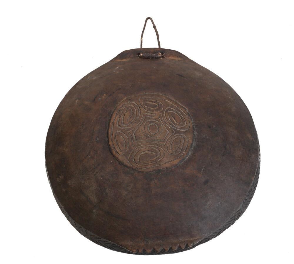 Papua New Guinea Feasting Bowl Tray carved raised traditional design: Papua New Guinea Feasting Bowl / Tray carved traditional design on the bottom, rim. 2.8Lbs Measurements: Approx. 13.75" x 3" Condition: Condition commensurate with age, use. some rubbing and wear to f