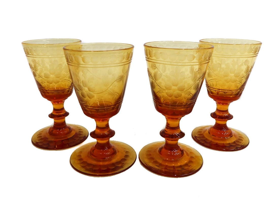 4 Bohemian Amber Cut Glass Cordial Wine Goblets Floral Design circa 1930: 4 Bohemian amber cut glass cordial wine goblets, circa 1930. Intaglio cut florals to central band and oval garland to base. Pontil underside. Weight: Approx. 2 lbs Measurements: Approx. 2 inches diame