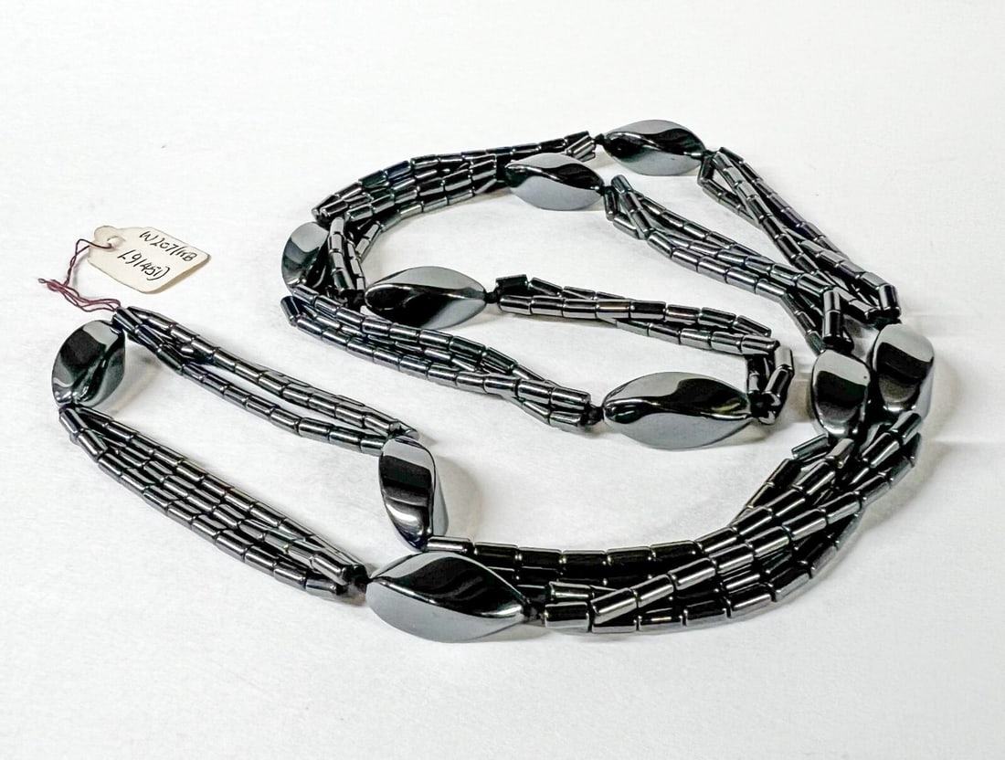 Vintage Continuous Hematite Multistrand Necklace 31": Continuous Hematite Multistrand Necklace, twist marquis alternating with three strands of tube beads. c1990. Measurements: Approx. 89.5grams total; 31 inches length; marquis 20mm length Condition: Exc