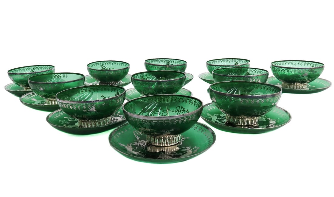 11 Murano Green Colored Glass and Silver Overlay Dessert Bowls and Underplates: 11 Murano green colored glass and silver overlay dessert bowls and underplates. Silver overlay horses to the center with a monogram "AR" Weight: Approx. 4 lb Measurements: Approx. 4 inches diameter x 