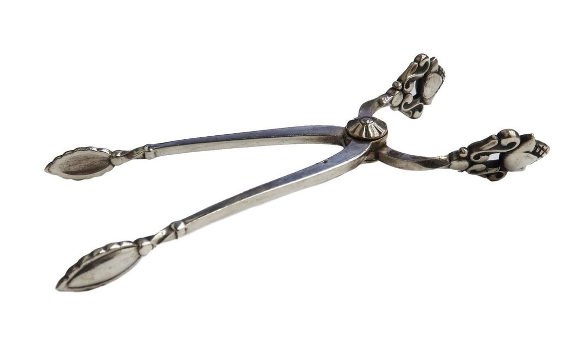 Georg Jensen Denmark Sterling Silver Scissor Sugar Tongs in Acorn circa 1920: Georg Jensen Denmark sterling silver scissor sugar tongs in Acorn circa 1920. Figural acorns to edge. Georg Jensen sterling silver hallmarks towards hinge. Weight: Approx. 25.85 grams Measurements: Ap