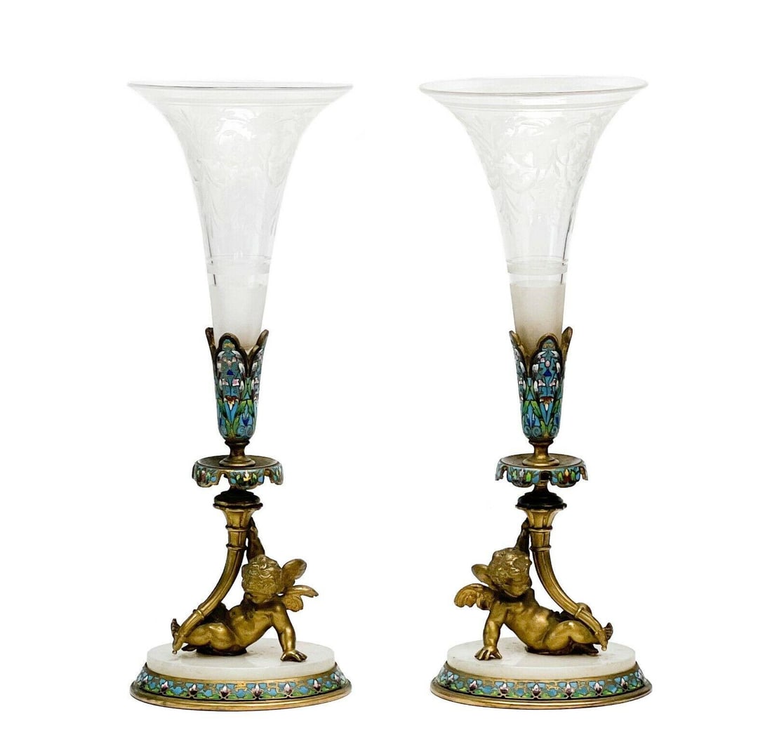 Pair French Champleve Enamel Bronze Putti Engraved Glass Trumpet Form Vases: Pair of French Champleve enamel gilt bronze putti mounted engraved glass trumpet form vases, late 19th century. Clear glass vases with etched floral and garland decoration. Gilt bronze figural putti t