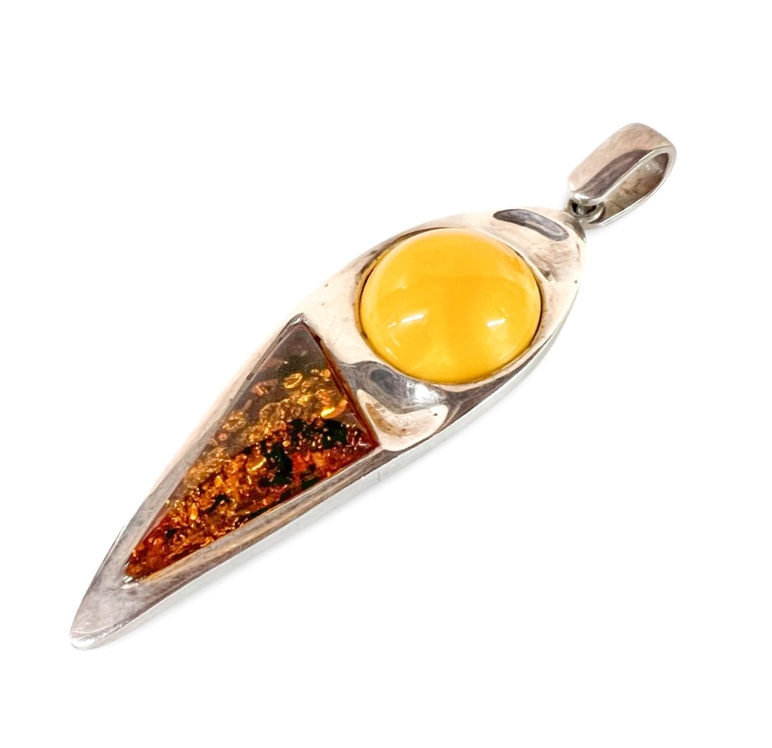 Vintage Modernist Baltic Amber and Sterling Silver Pendant: Vintage Modernist Amber and Sterling Silver Pendant; butterscotch and cognac baltic amber. Large bale. Marked 925 on the bale. c1970-80. Measurements: Approx. 25.39grams; 3 inches length without bale;