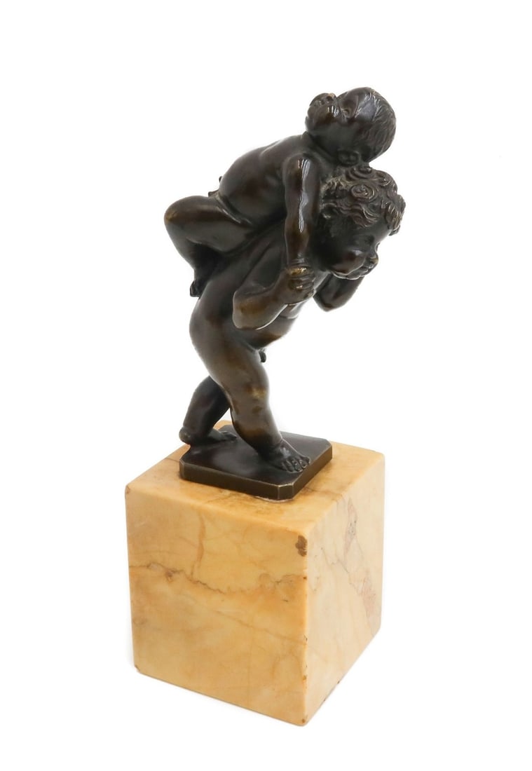 German Patinated Bronze Figurine of Putti Playing Piggyback after Leonhard Kern: German patinated bronze figurine of Putti Playing Piggyback after Leonhard Kern (German 1588 - 1662). Mounted to square marble base. Possibly 18th Century or Earlier. Weight: Approx. 2.2 lbs Measureme