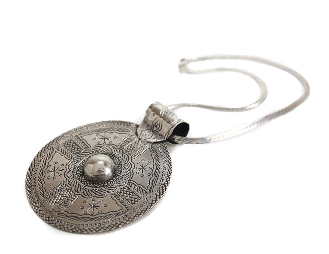 Large 800 Silver hand engraved Egyptian Siwa Disk Pendant Choker Chain 15 in: Large 800 Silver hand engraved Egyptian Siwa Disk Pendant on 15inches flat sterling silver snake chain. c1975. Raised dome in center, Hallmark on reverse side of pendant, chain marked Sterling 925. 44