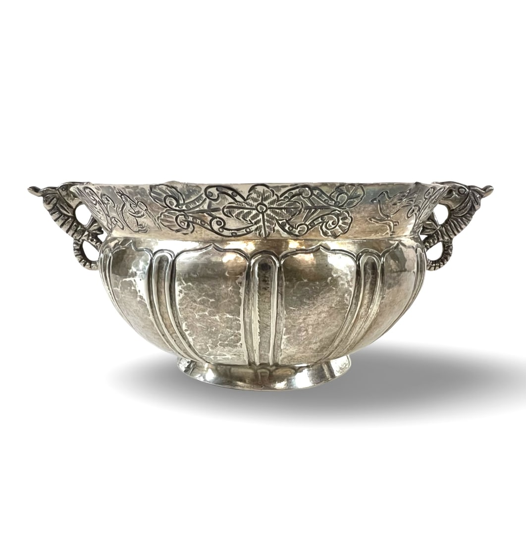 18th Century Spanish Colonial hand wrought silver bowl likely Guatemalan: 18th Century Spanish Colonial hand wrought silver bowl, likely Guatemalan. Lobed sides, dual dolphin/fish scroll handles, engraved band of animals and plants on the flared rim. Marks on the bottom ill