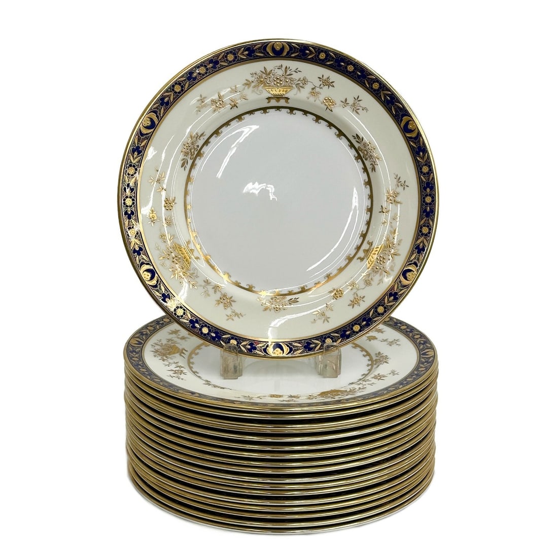 18 Minton England Porcelain Gold Encrusted Dinner Plates in Dynasty: 18 Minton England porcelain dinner plates in Dynasty, Mid Century. Cobalt blue ground to rim with gold encrusted florals. Minton England mark to underside. Weight: Approx. 22.5 lb Measurements: Approx